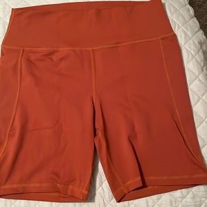Like new orange 7” inseam Senita shorts